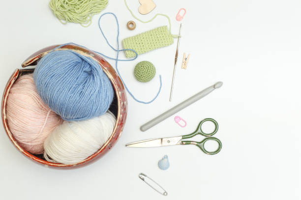 istock wool yarn for knitting and needlework, knitting hooks and accessories on a light background, with space 1300886997