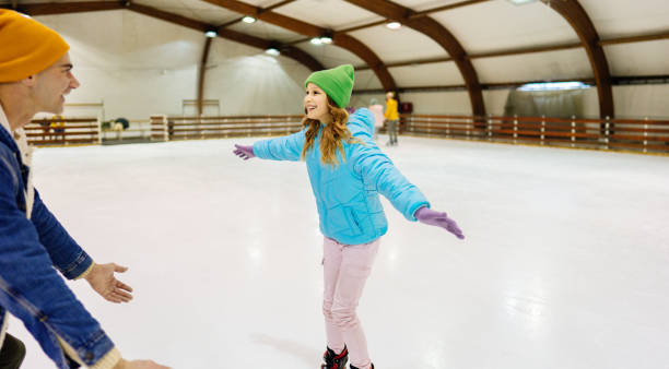 istock Hey dad, I'm ice-skating! 1300887382