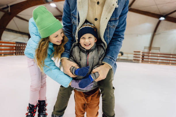 istock Learning how to ice-skate with my dad and sister 1300887612