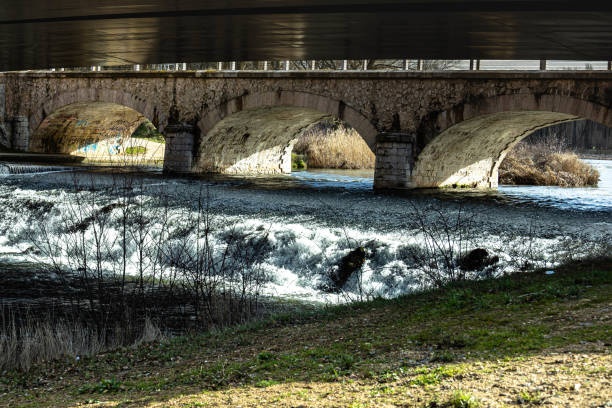 istock selective focus of a small waterfall located under a bridge with several arches 1300889518