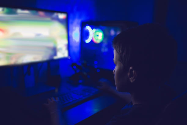 istock Modern gamer boy playing video games on his computer in his game room 1300889580