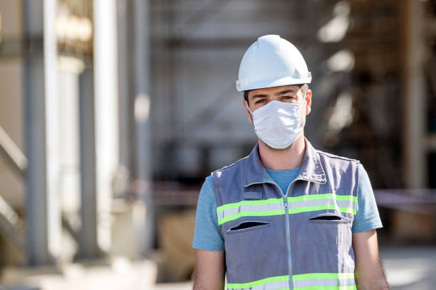 istock The worker (staff, engineer) protects himself from covid-19 (coronavirus) with a protective mask in the construction site. 1300889584
