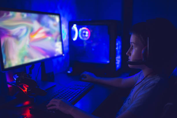 istock Modern gamer boy playing video games on his computer in his game room 1300889709