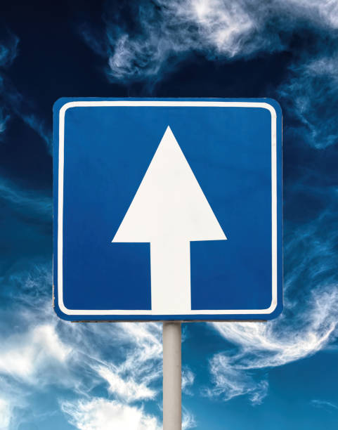 istock White arrow on a blue background. One-way traffic warning sign 1300890071
