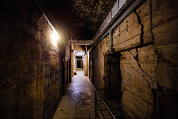 istock Dark creepy old corridor of underground bunker or prison 1300891748