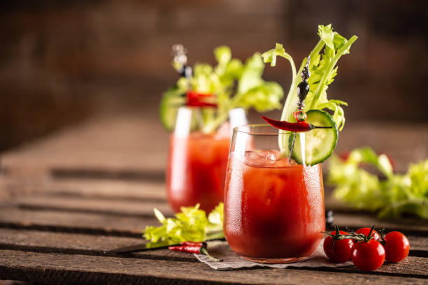 Bloody or virgin mary cocktail served in a cup with celery sticks and cherry tomatoes. Bloody or virgin mary cocktail served in a cup with celery sticks and cherry tomatoes. bloody mary stock pictures, royalty-free photos & images