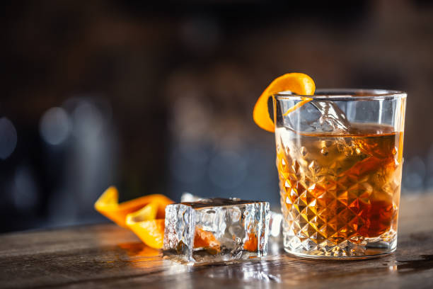 istock Old fashioned rum drink on ice with orange zest garnish. 1300893214