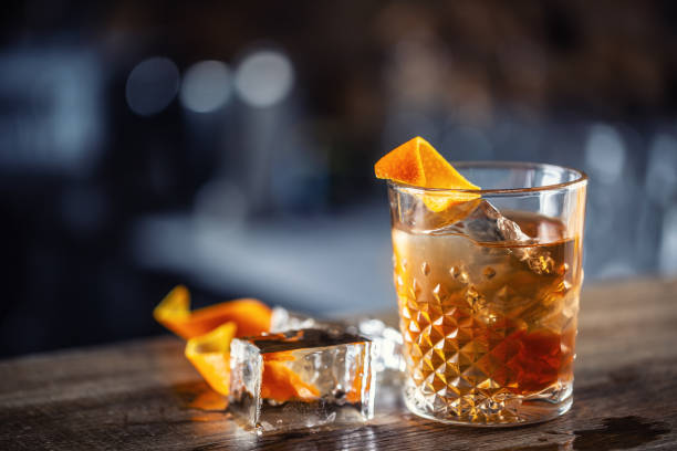 istock Old fashioned rum drink on ice with orange zest garnish. 1300893287