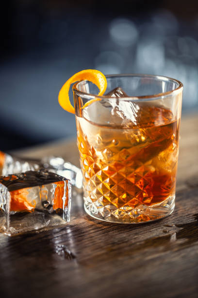 istock Old fashioned rum drink on ice with orange zest garnish. 1300893322
