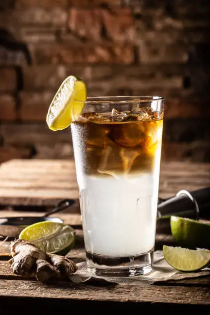 Photo of Dark n Stormy highball cocktail served as a long drink with rum, fresh lime juice, and ginger beer.