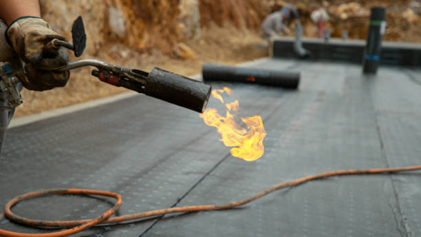 istock CLOSE UP: Builder holds a burning blowtorch after hydroisolating a building. 1300895110