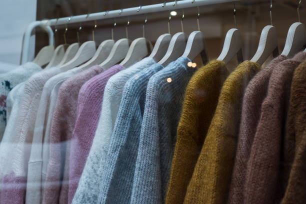 istock woolen pullovers set on hangers in a fashion store showroom 1300895127