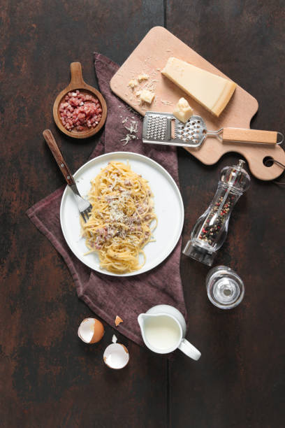 spaghetti carbonara with italian cheese and bacon - recipe ingredient grater cheese grater imagens e fotografias de stock