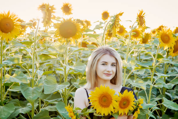 istock girl in sunflowers 1300895457