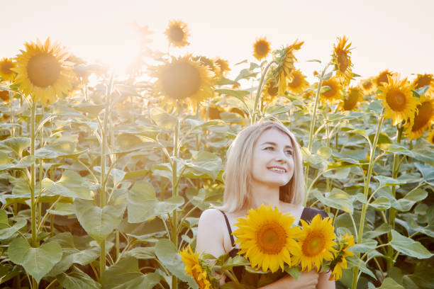 istock girl in sunflowers 1300895964