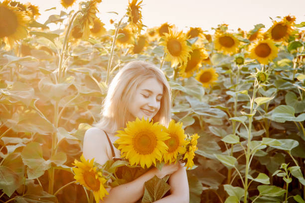 istock girl in sunflowers 1300895971