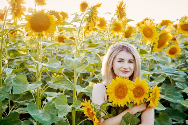 istock girl in sunflowers 1300895978