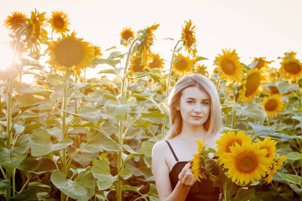 istock girl in sunflowers 1300896024