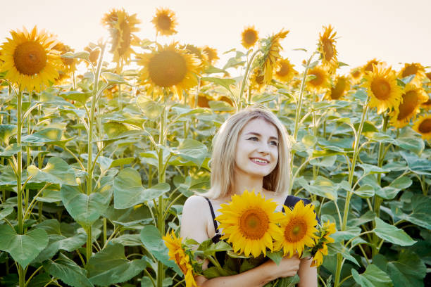 istock girl in sunflowers 1300896061