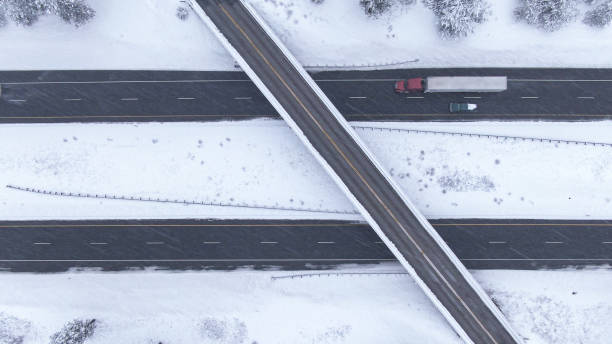 istock TOP DOWN: Flying above a highway overpass in USA during an intense blizzard. 1300896177