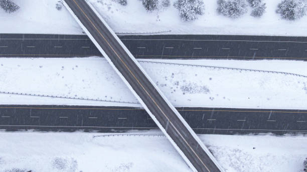 istock TOP DOWN: Flying over a highway overpass in the middle of an intense blizzard. 1300896211