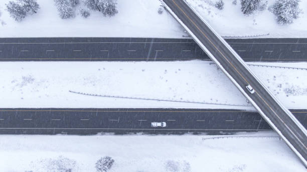 istock TOP DOWN: Flying over a highway overpass in USA during an intense blizzard. 1300896231
