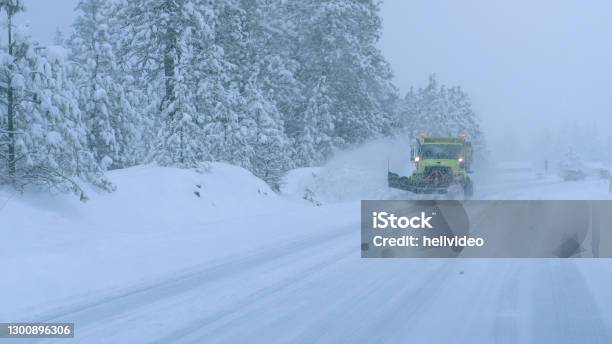 Close Up Truck Plows The Snowy Country Road During A Horrible Snowstorm Stock Photo - Download Image Now