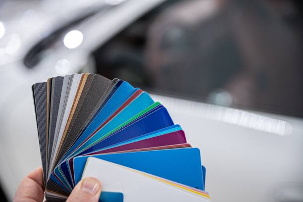 istock Man choosing color of his car with color sampler. 1300896345
