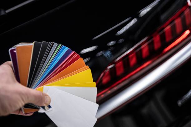 istock Man choosing color of his car with color sampler. 1300896391