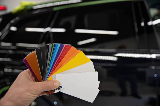 istock Man choosing color of his car with color sampler. 1300896411