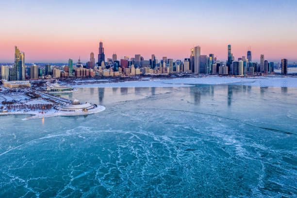 Chicago Skyline and Frozen Lake Michigan - Aerial View Aerial View of Chicgo skyline at sunrise, frozen Lake Michigan and sea smoke chicago illinois stock pictures, royalty-free photos & images