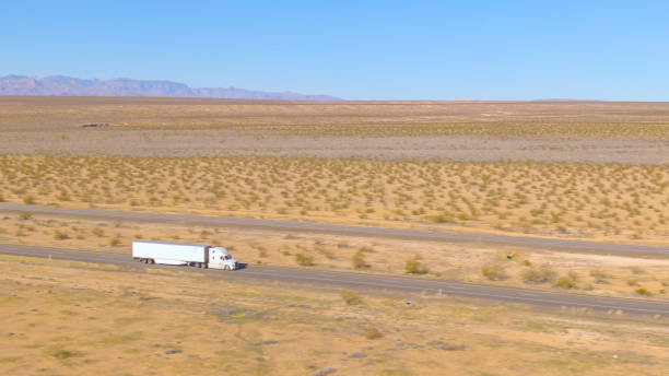 istock DRONE: Flying above white cargo truck enduring a long drive across Utah desert. 1300897155