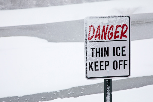 Warning sign at edge of lake, Keep Off!