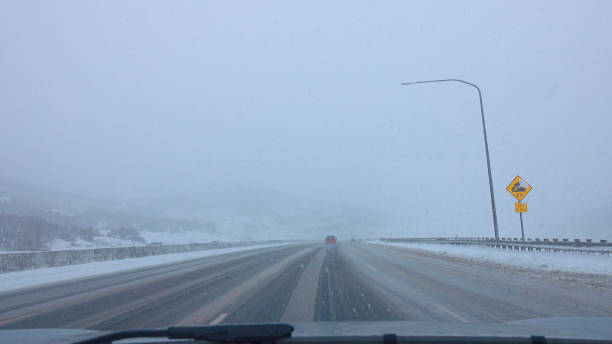 istock POV: Driving down an icy and snowy interstate freeway during an extreme blizzard 1300898922