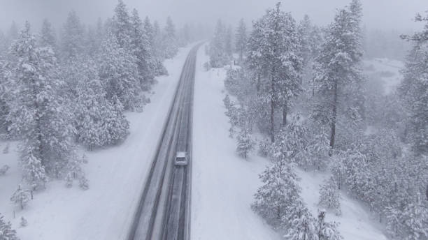 istock DRONE Flying behind a car driving through a snowstorm as commuter drives to work 1300898945