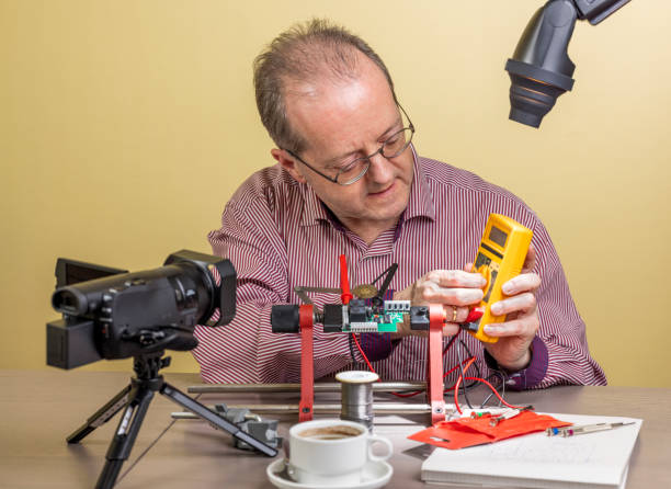 istock Operating a multimeter, a middle aged man is working from home, vlogging electronic repair instructions as side hustle for his social media followers 1300900589