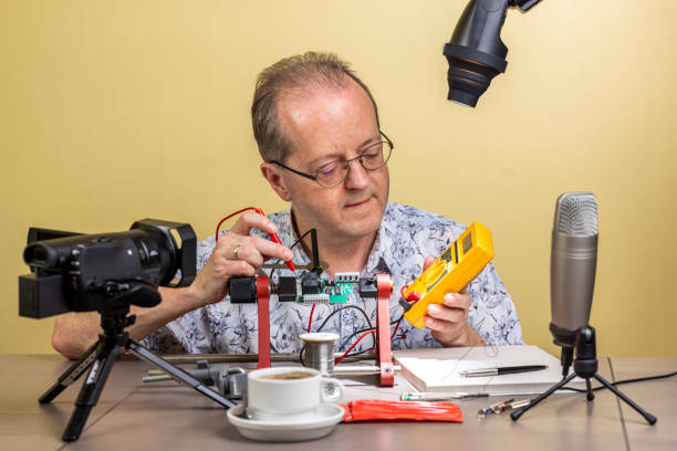 istock Measuring a voltage with his multimeter, a middle aged man is working from home, vlogging electronic repair instructions as side hustle for his social media followers 1300900850