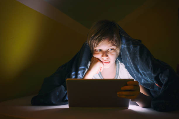 istock Little boy watching cartoons after bed time 1300905171