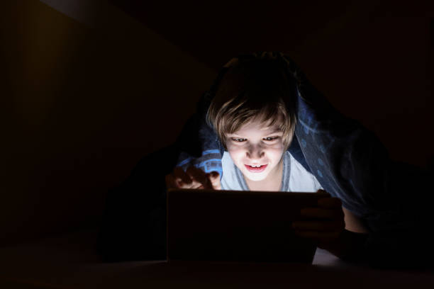 istock Little boy watching cartoons after bed time 1300905190