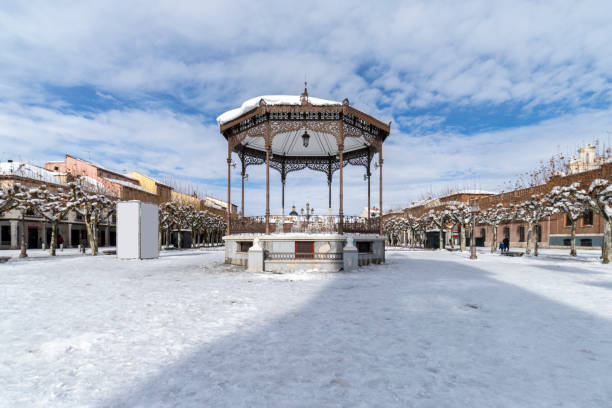 Cervantes square in the city of alcala de henares covered in snow with the bandstand in the foreground horizontal view of cervantes square in the city of alcala de henarees covered of snow with the bandstand in the foreground alcala de henares stock pictures, royalty-free photos & images