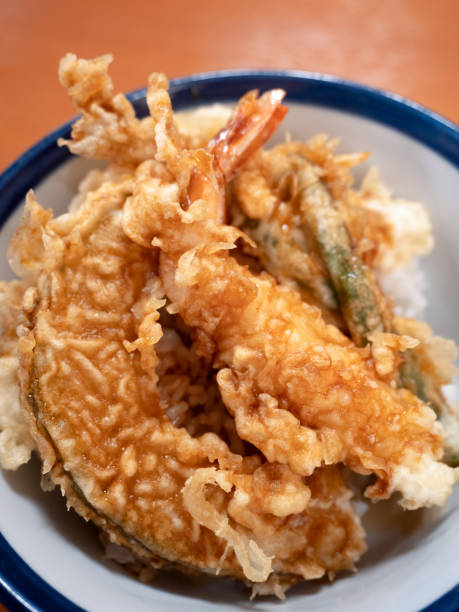 istock Bowl of rice and fried fish 1300909432