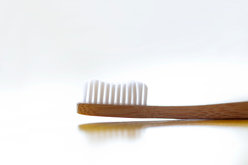 bamboo toothbrush on wooden backgroun, ocean and earth friendly. shot with dslr camera Canon 5dsr