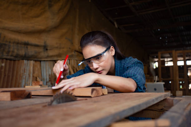 istock pretty hardworking carpenter woman at workplace 1300922654