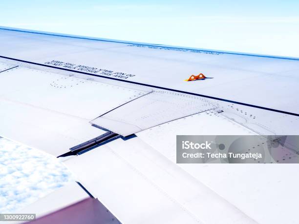 Yellow Little Hook On Airplane Wing Stock Photo - Download Image Now - Aircraft Wing, Hook - Equipment, Airplane