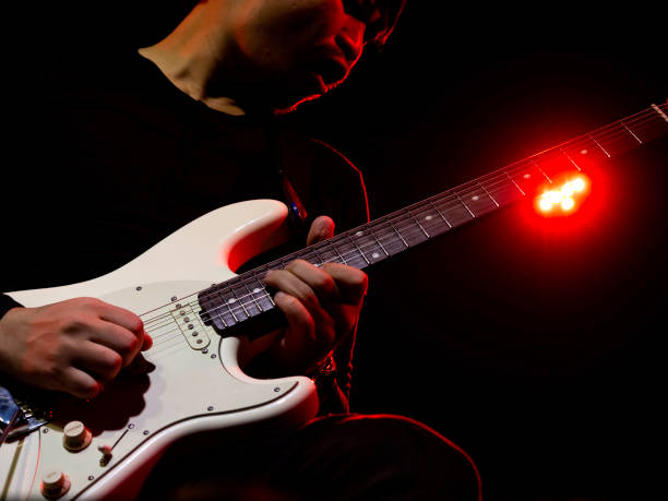 istock Musician plaing guitar in concert. 1300922922