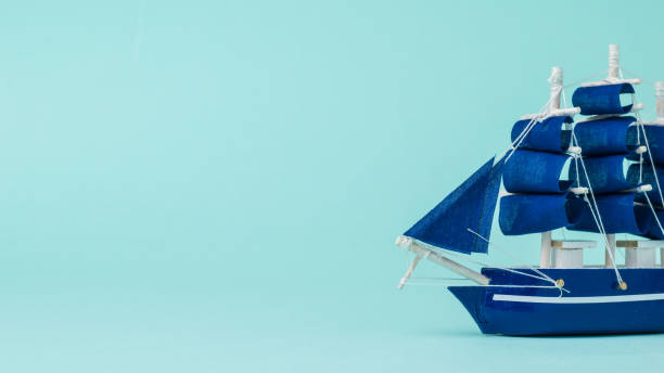 istock Installation of a sailboat floating on the side on a blue background. 1300924606