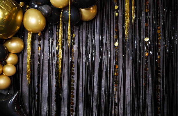 istock Shiny gold, black balloons. New year baubles, glossy sparkles. 1300927846