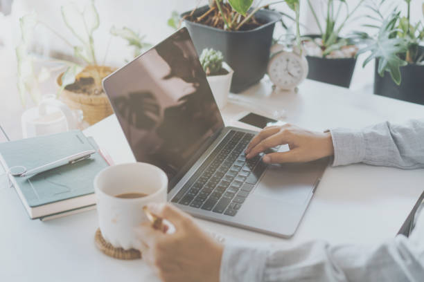istock Woman is working on clean nature workspace at home with laptop, planner notebook and calculator. Business finance office concept. 1300927898