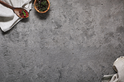 Top view of food ingredients on grey concrete. TExtile Napkin and wooden spoon