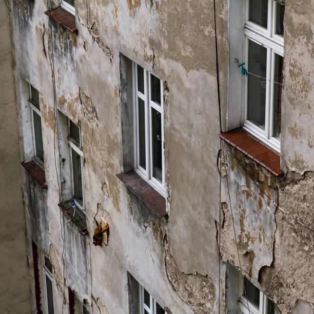 istock Old and ruined house facade, dirt and broken windows 1300929612
